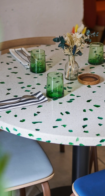 Il piano del tavolo è realizzato in terrazzo cristal white e verde