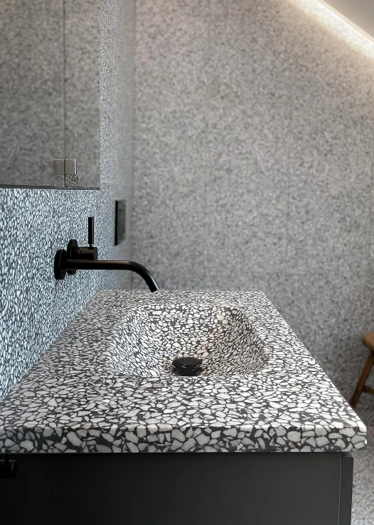 The sink is decorated with black and white terrazzo for the Bathroom