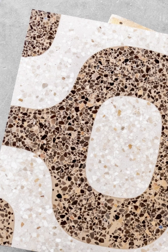 The terrazzo tiles are adorned with a cream, beige, and brown pattern