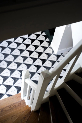 The floor has been adorned with a combination of white and black terrazzo