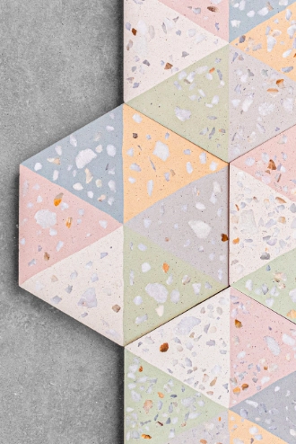 The terrazzo has triangles in cream, yellow, pink, gray, green, and blue colors